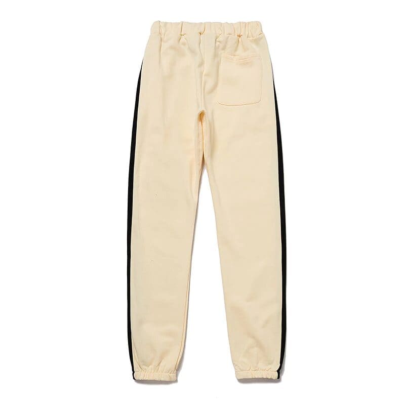 White jogger pants with black side stripes, casual streetwear style for K-pop fans.