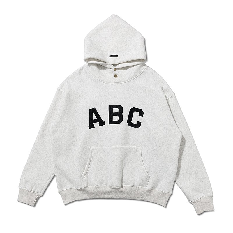 ABC hoodie with a front pocket, perfect for casual streetwear, featuring bold black letters on a white background.