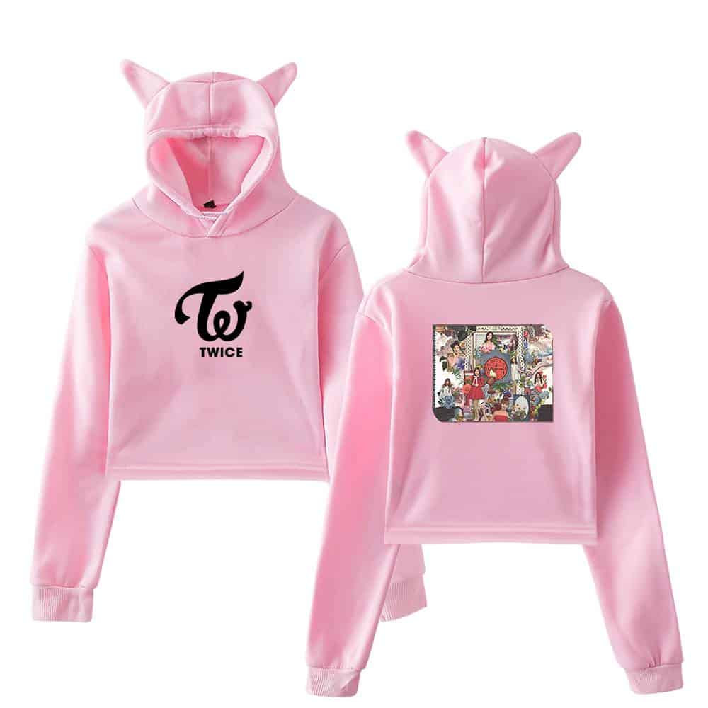 Twice kpop merch pink hoodie with cat ears, TWICE logo on front, colorful album art on back, suitable for fans and collectors of K-pop apparel.
