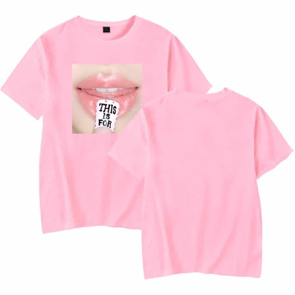 Pink T-shirt featuring a close-up graphic of lips holding a tag that says "This is for" in black text.